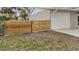 Side yard with new wood fence and gate, next to garage at 20191 Gladstone Ave, Port Charlotte, FL 33952