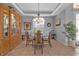 Bright dining room with glass table and hutch at 2163 Silver Palm Rd, North Port, FL 34288