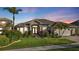 Luxury home exterior at dusk showcasing its curb appeal at 2163 Silver Palm Rd, North Port, FL 34288