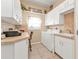 Bright laundry room with washer, dryer, and built-in workspace at 2163 Silver Palm Rd, North Port, FL 34288