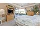 Bright main bedroom with a king-size bed and built-in entertainment center at 2163 Silver Palm Rd, North Port, FL 34288