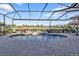 Screened-in pool with brick pavers and lush landscaping at 2163 Silver Palm Rd, North Port, FL 34288