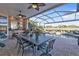 Outdoor kitchen and dining area overlooking the screened pool at 2163 Silver Palm Rd, North Port, FL 34288