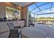 Outdoor kitchen and patio furniture with a view of the pool at 2163 Silver Palm Rd, North Port, FL 34288