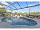 Relaxing kidney-shaped pool surrounded by lush landscaping at 2163 Silver Palm Rd, North Port, FL 34288