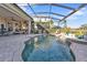 Resort-style pool with screened patio and outdoor kitchen at 2163 Silver Palm Rd, North Port, FL 34288