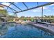 Relaxing freeform pool with a screened enclosure and patio at 2163 Silver Palm Rd, North Port, FL 34288
