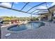 Inviting kidney-shaped pool with screened enclosure and patio at 2163 Silver Palm Rd, North Port, FL 34288