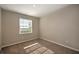 Well-lit bedroom with carpet and a window at 23343 Collina Way # 203, Punta Gorda, FL 33980