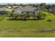 Aerial view of house with pool and lush landscaping at 303 Paramaribo St, Punta Gorda, FL 33983