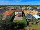 House with backyard patio, screened pool enclosure, and hedges at 4261 River Bank Way, Punta Gorda, FL 33980