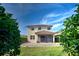 Two-story house with a backyard patio and screened porch at 4261 River Bank Way, Punta Gorda, FL 33980