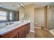 Main bathroom with double vanity and a large shower at 4261 River Bank Way, Punta Gorda, FL 33980