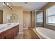 Bathroom boasts a double vanity, shower, and bathtub at 4261 River Bank Way, Punta Gorda, FL 33980