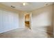 Bedroom with carpet, double door closet and access to hallway at 4261 River Bank Way, Punta Gorda, FL 33980