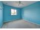 Blue bedroom with carpet and window at 4261 River Bank Way, Punta Gorda, FL 33980