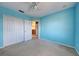 Blue bedroom with carpet and double door closet at 4261 River Bank Way, Punta Gorda, FL 33980