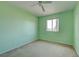 Light green bedroom with carpet and window at 4261 River Bank Way, Punta Gorda, FL 33980