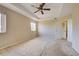 Large bedroom with neutral walls and ceiling fan at 4261 River Bank Way, Punta Gorda, FL 33980