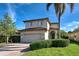Two-story house with a two-car garage and manicured lawn at 4261 River Bank Way, Punta Gorda, FL 33980