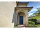 Dark blue front door with arched entryway at 4261 River Bank Way, Punta Gorda, FL 33980