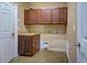 Laundry room with wood cabinets and countertop at 4261 River Bank Way, Punta Gorda, FL 33980