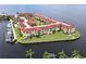 Aerial view showcasing the waterfront condo complex, beautifully landscaped grounds, and private boat docks for residents at 1 Colony Point Dr # 3C, Punta Gorda, FL 33950