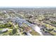 Wide aerial shot capturing a residential area with canal-front homes, docks, and verdant landscapes at 4107 Rock Creek Dr, Port Charlotte, FL 33948