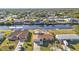 Aerial view of a waterfront property with canal access and lush surroundings in a residential neighborhood at 4107 Rock Creek Dr, Port Charlotte, FL 33948