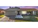 Well-maintained home with a gray front door, and a two-car garage, and gray stone pathway at 4107 Rock Creek Dr, Port Charlotte, FL 33948