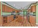 Traditional kitchen with wood cabinets, center island, laminate flooring, and stainless steel appliances at 4107 Rock Creek Dr, Port Charlotte, FL 33948