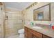 Bright bathroom features tiled walls, glass enclosed shower, and granite countertop vanity at 109 Peckham Se St, Port Charlotte, FL 33952