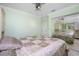 Light green bedroom with a ceiling fan and a mirrored closet at 109 Peckham Se St, Port Charlotte, FL 33952