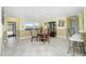 Dining area with tile floors, glass table, and a large window overlooking the backyard at 109 Peckham Se St, Port Charlotte, FL 33952