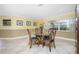 Dining area with tile floors, glass table, and a large window overlooking the backyard at 109 Peckham Se St, Port Charlotte, FL 33952