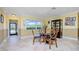 Dining area with tile floors, glass table, and a large window overlooking the backyard at 109 Peckham Se St, Port Charlotte, FL 33952