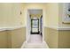 Bright foyer with neutral walls, elegant crown molding, and views into the front yard at 109 Peckham Se St, Port Charlotte, FL 33952
