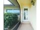 Inviting front entryway featuring a decorative glass door and manicured landscaping at 109 Peckham Se St, Port Charlotte, FL 33952