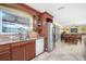 Open kitchen leading to dining and living area with stainless steel refrigerator at 109 Peckham Se St, Port Charlotte, FL 33952