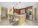 Kitchen featuring wooden cabinetry, stainless steel appliances, granite countertops, and bar seating at 109 Peckham Se St, Port Charlotte, FL 33952