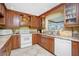 Bright kitchen with wood cabinets, granite countertops, and a view to the outside at 109 Peckham Se St, Port Charlotte, FL 33952