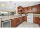 Spacious kitchen featuring a wine cooler, granite counters, and wood cabinets at 109 Peckham Se St, Port Charlotte, FL 33952