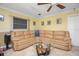 Cozy living room area with a large sectional sofa and tile floors at 109 Peckham Se St, Port Charlotte, FL 33952