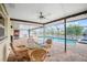 Screened patio has a brick floor, an outdoor dining set, and a view of the pool at 109 Peckham Se St, Port Charlotte, FL 33952