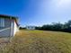 Spacious back yard featuring a shed and chain link fence at 12143 Du Barry Ave, Port Charlotte, FL 33981