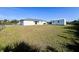 Spacious backyard features a fenced lawn and a detached shed at 12143 Du Barry Ave, Port Charlotte, FL 33981