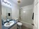 Bathroom with a shower-tub, sink, mirror, and toilet at 12143 Du Barry Ave, Port Charlotte, FL 33981