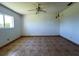 Bright bedroom with neutral walls, tile floors, and ceiling fan, creating a peaceful retreat at 12143 Du Barry Ave, Port Charlotte, FL 33981