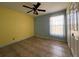 Bright bedroom featuring neutral tile flooring, ceiling fan, and natural light from a window at 12143 & 12151 Dubarry Ave, Port Charlotte, FL 33981