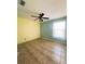 Bright bedroom featuring neutral tile flooring, ceiling fan, and natural light from a window at 12143 Du Barry Ave, Port Charlotte, FL 33981